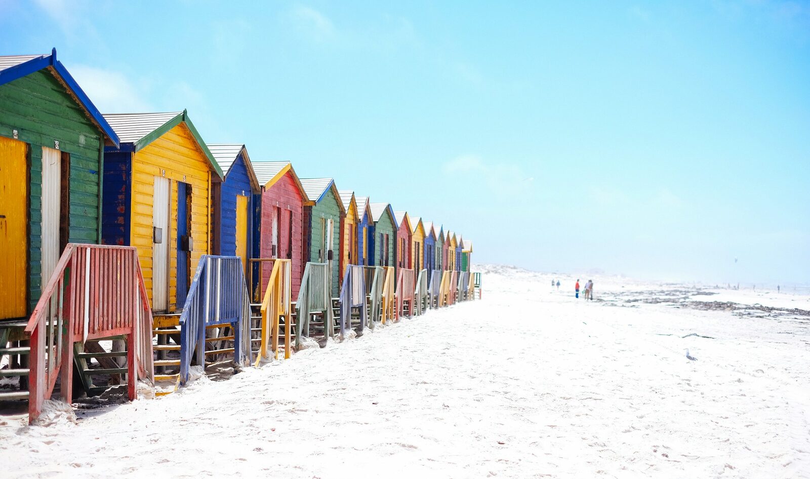 The row of brightly painted Victorian bathing boxes on the beach at Muizenberg.